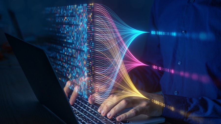 Hands typing on a laptop keyboard.