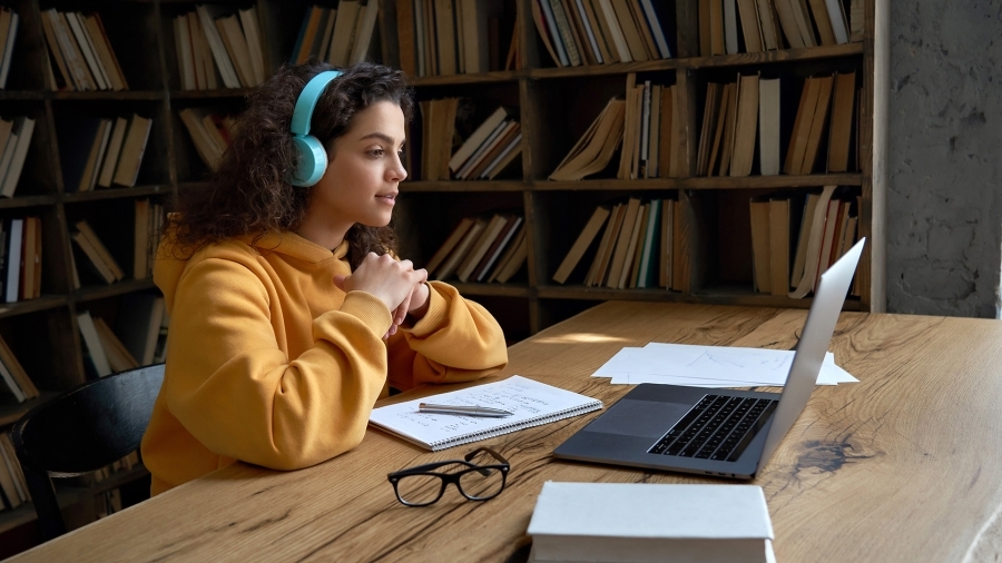 A student using a laptop in the library.