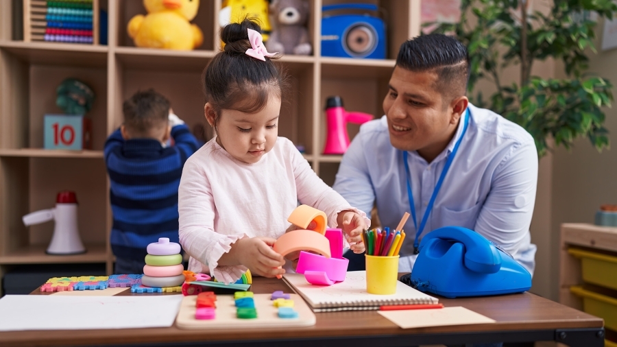 A teacher helping a young student.