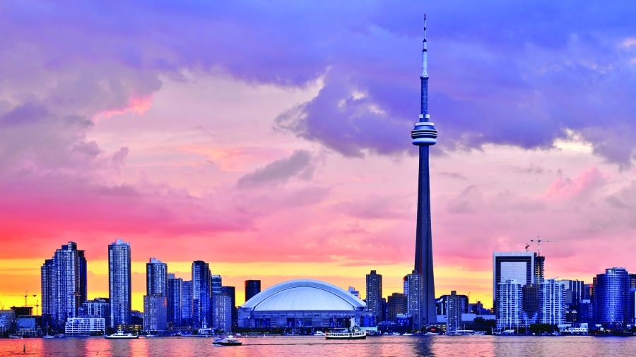 A photo of the Toronto skyline at sunset.